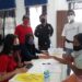 Sekdes Teluk Lawah, Samsudin (mengenakan topi) dan lainnya saat menyaksikan penyaluran BLT DD tahap V dan VI kepada masyarakat tidak mampu terdampak COVID-19, di gedung pertemuan desa setempat, Jumat (23/10/2020). (FOTO : PWI Gunung Mas)
