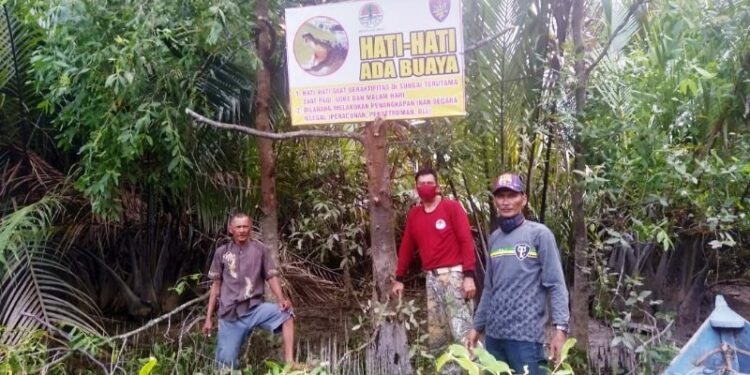 Tim BKSDA Kalteng Pos Sampit memasang papan peringatan di lokasi serangan buaya di Desa Lampuyang Kecamatan Teluk Sampit, Selasa (27/10/2020). (ANT/IST)