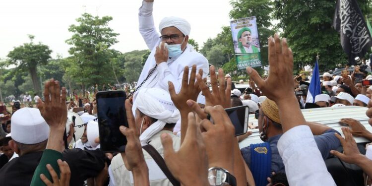 Habib Rizieq Shihab (HRS) menyapa massa yang menjemputnya di Terminal 3 Bandara Soekarno Hatta, Tangerang, Banten, Selasa (10/11/2020). HRS beserta keluarga kembali ke tanah air setelah berada di Arab Saudi selama tiga tahun. ANTARA FOTO/Muhammad Iqbal/aww.