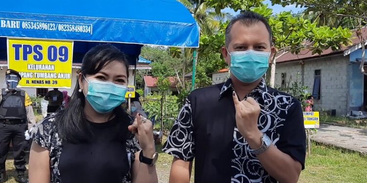 Bupati Gumas Jaya S Monong dan istri menunjukkan jari yang sudah ditetesi tinta, usai menggunakan hak pilih di TPS 9 Kelurahan Tampang Tumbang Anjir, Kecamatan Kurun, Rabu (9 Desember 2020). (ANT)