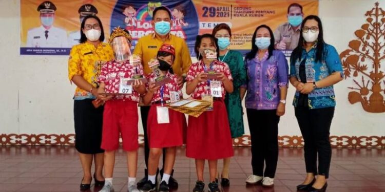 Kepala Dinas Perpustakaan dan Kearsipan Kabupaten Gumas Edwin Yustian bersama Guru Pembina dan Pendamping dari SD Negeri 3 Tampang Tumbang Anjir, Yuni Herniasihati, para juara lomba bercerita, dan lainnya. (IST)