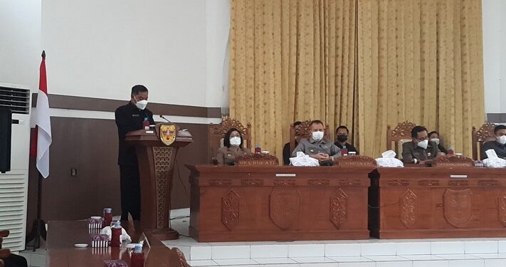 Anggota DPRD Gumas Untung J Bangas (kiri) membacakan keputusan DPRD Gumas tentang rekomendasi terhadap LKPJ Bupati tahun 2020, saat rapat paripurna di Kuala Kurun, Rabu (21/7/2021).