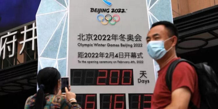 Ilustrasi - Seorang perempuan menggunakan telepon genggamnya di depan jam hitung mundur yang memperlihatkan 200 hari sebelum pembukaan Olimpiade Musim Dingin Beijing 2022 di Beijing, China, Senin (19/7/2021). (ANT/FOTO/REUTERS/Tingshu Wang/hp/cfo)