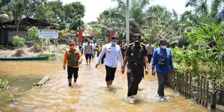 Bupati H Hendra Lesmana beserta unsur pejabat Lamandau saat meninjau rumah warga yang terdampak banjir, kemarin.