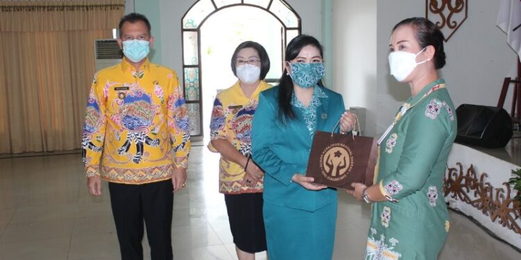 Ketua TP PKK Kabupaten Gumas, Mimie Mariatie Jaya S Monong didampingi Bupati Jaya S Monong dan Wakil Bupati Efrensia L.P Umbing menyerahkan cendera mata kepada narasumber, saat rakerda TP PKK kabupaten di GPU Damang Batu, Kamis (30/9/2021). (Foto : Diskominfosantik Kabupaten Gumas)