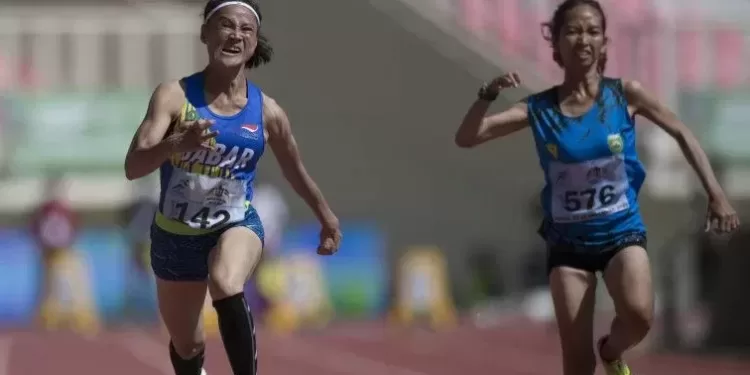 Pelari putri Jawa Barat Insan Nurhaida (kiri) beradu cepat dengan pelari Sumatera Selatan Endang Purwita Sari (kanan) pada final nomor 100 meter putri klasifikasi T35-T36 di Stadion Lukas Enembe, Kabupaten Jayapura, Papua, Selasa (9/11/2021). Insan Nurhaida berhasil membuat rekor nasional dengan catatan waktu 16,51 detik. (MASAPNEWS/ANT)