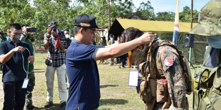 Wabup Lamandau Riko Porwanto saat menyempatkan tanda peserta kepada salah satu peserta Lamandau Milsim 2021, kemarin.