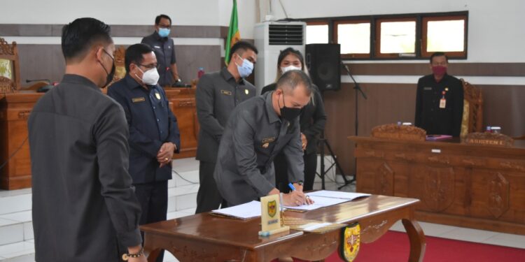 Bupati Gumas Jaya S Monong saat menandatangani berita acara atas 3 buah Raperda yang disaksikan ketua dan Wakil ketua DPRD setempat, Rabu (17/11/2021) (FOTO : DISKOMINFOSANTIK KAB GUMAS)