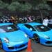Petugas kepolisian melihat barang sitaan milik tersangka kasus dugaan penipuan investasi trading binary option lewat aplikasi Quotex Doni Salmanan di halaman Bareskrim Polri, Jakarta, Senin (14/3/2022). (MASAPNEWS/ANT)