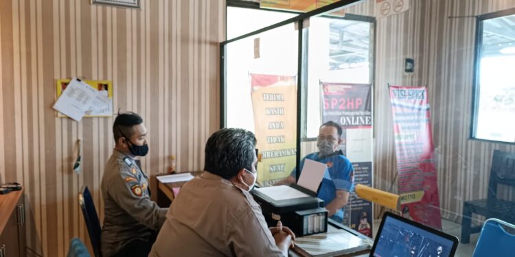 Ketua PWI Kabupaten Gumas Popy Oktovery (baju biru) melaporkan oknum wartawan di Kantor SPKT Polres Gumas, Selasa (17/5/2022). (Foto : PWI Kabupaten Gumas)