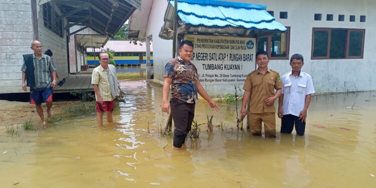 Legislator Kabupaten Gumas, Pebrianto didampingi Kades dan Sekdes Tumbang Kuayan meninjau kondisi sekolah yang terkena banjir di desa setempat, saat reses perorangan baru-baru ini. (IST)