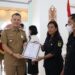 Bupati Gunung Mas, Jaya S Monong menyerahkan piagam penghargaan kepada masyarakat Desa Bereng Malaka, yang diterima secara simbolis oleh BPD Bereng Malaka, di Kuala Kurun, Senin (7/11/2022). (Foto : Diskominfosantik Gumas)